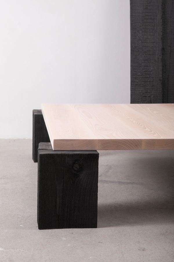 square coffee table with blackened wood legs